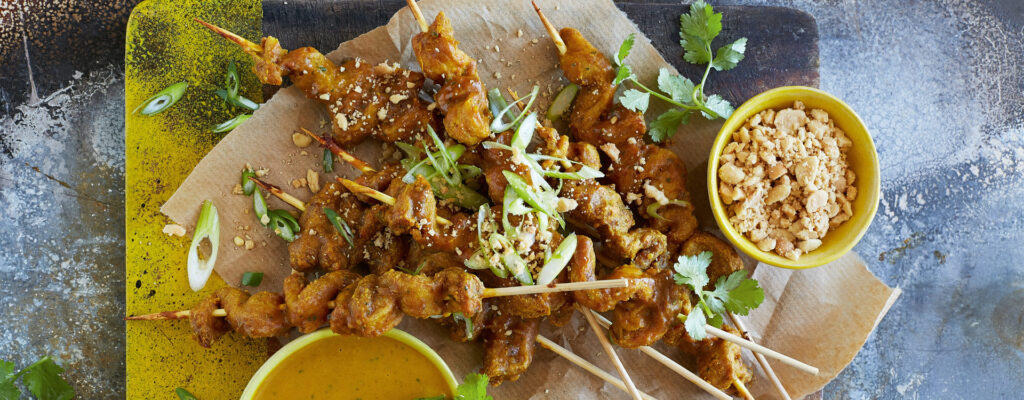 Chicken curry kebabs on platter with dipping sauces