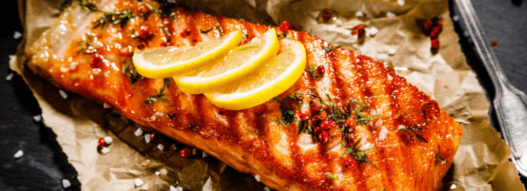 Barbecued fish with lemon slices on top