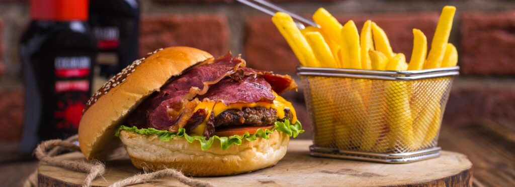 Burger and fries on a wooden board